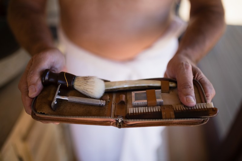 Man holding a shaving kit